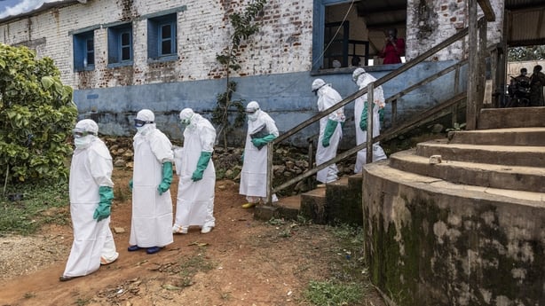 Health workers wearing protective equipment walk outside the General Referral Hospital of Mongbwalu during the Ebola outbreak response in Bunia, Democratic Republic of Congo.