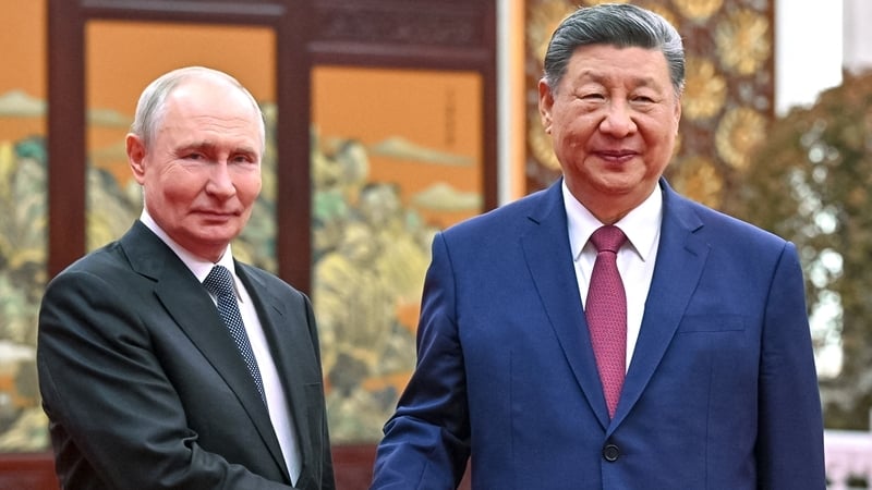 In this pool photograph distributed by the Russian state agency Sputnik, Russia's President Vladimir Putin and China's President Xi Jinping hold a tea chat in Beijing on May 20, 2026. (Photo by Kristina Solovyova / POOL / AFP)