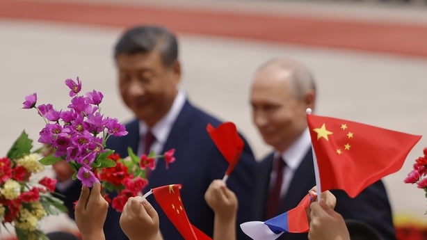 BEIJING, CHINA - MAY 20: Children wave flags and flowers as Russian President Vladimir Putin and Chinese President Xi Jinping attend a welcoming ceremony at the Great Hall of the People on May 20, 2026 in Beijing, China. The two leaders are expected to reaffirm strategic ties between Russia and Chin