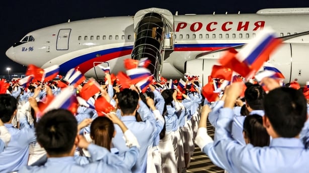 In this pool photograph distributed by the Russian state agency Sputnik, Russia's President Vladimir Putin boards his airplane at Beijing Capital Airport as he departs Beijing on May 20, 2026, after a two-day visit. (Photo by Alexander KAZAKOV / POOL / AFP)