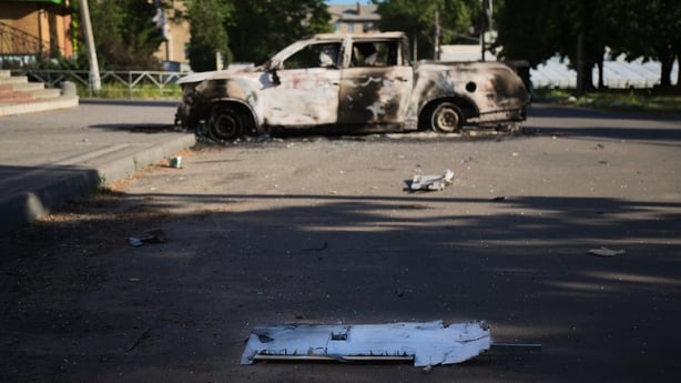 The wing of a Russian Molniya FPV drone lays beside a burned vehicle near the church on the central square Sloviansk, Ukraine.