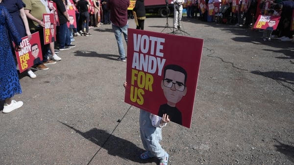 2 year old Olivia Bilham holds a placard of Andy Burnham