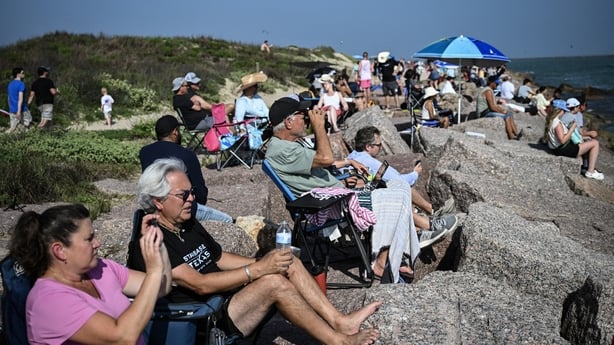 People watch the launch of SpaceX's Starship 39 rocket from Starbase as they gather in South Padre Island, Texas,