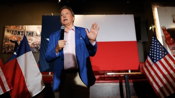 Ken Paxton, Texas attorney general and Republican US Senate candidate, standing in front of a Texan flag.