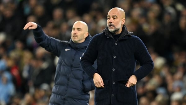 Pep Guardiola, Manager of Manchester City, reacts as Enzo Maresca, Manager of Chelsea (obscured), gives the team instructions during the Premier League match between Manchester City FC and Chelsea FC at Etihad Stadium on January 25, 2025 in Manchester, En