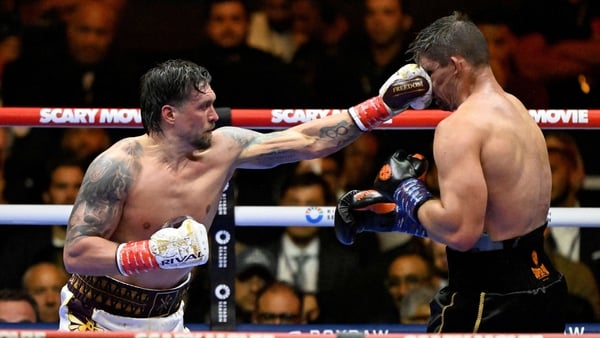 Oleksandr Usyk (L) lands a punch on Netherlands' Rico Verhoeven (R)