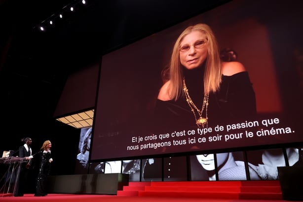 CANNES, FRANCE - MAY 23: Isabelle Huppert accepts the Honorary Palme d'Or on behalf of Barbra Streisand from host Eye Haïdara on stage during the closing ceremony of the 79th annual Cannes Film Festival at Palais des Festivals on May 23, 2026 in Cannes, France. (Photo by Stephane Cardinale - Corbis/