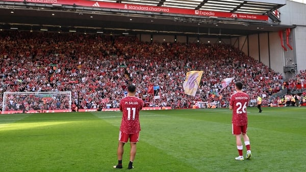 Mohamed Salah and Andrew Robertson of Liverpool applaud the fans on the pitch following their guard of honour after the Premier League match between Liverpool and Brentford at Anfield on May 24, 2026 in Liverpool, England.
