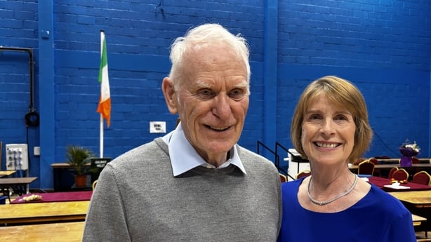 A man and woman simling at the camera in a count centre