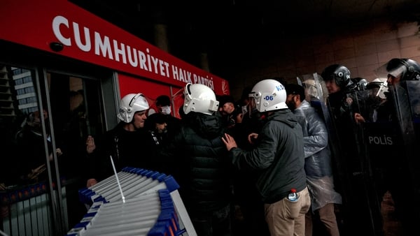 Turkish riot police officers attempt to enter the Republican People's Party (CHP) headquarters as they use tear gas in Ankara, on May 24, 2026. Hundreds of Turkish riot police using teargas forced their way into the Ankara headquarters of the main CHP opp