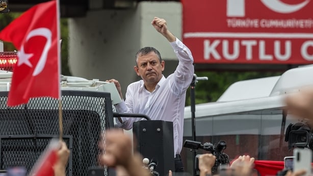 Turkey's main opposition Republican People's Party's (CHP) Ousted party leader Ozgur Ozel waves to supporters from atop a police water cannon vehicle after being forcibly evicted by police from his party's headquarters on May 24, 2026 in Ankara, Turkey. Police forcibly took control of the headquarte