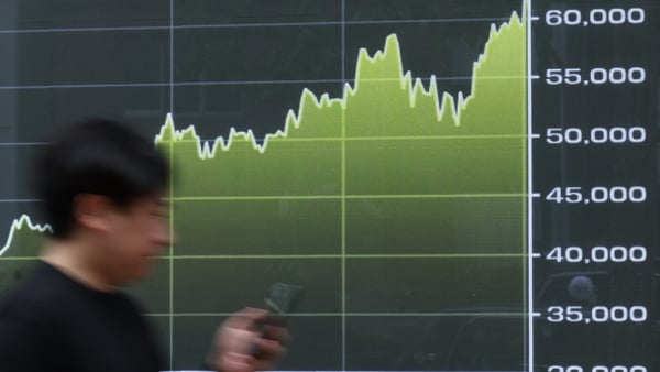 A graph tracking the movement of the Nikkei 225 Stock Average displayed outside a securities firm in Tokyo, Japan, on Friday, May 8, 2026. Asian stocks pulled back from a record high and crude oil rose as escalating tensions in the Middle East revived con