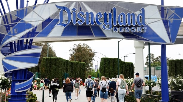ANAHEIM, CALIFORNIA - APRIL 24: People walk toward an entrance to Disneyland on April 24, 2023 in Anaheim, California. Disney will lay off several thousand workers this week amid an overall push by the media giant to cut 7,000 total jobs in an effort to save $5.5 billion in costs. (Photo by Mario Ta
