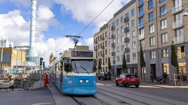 A blue and white tram seen on a street in Gothenburg in Sweden