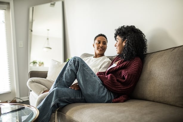 Lesbian couple at home relaxing on couch