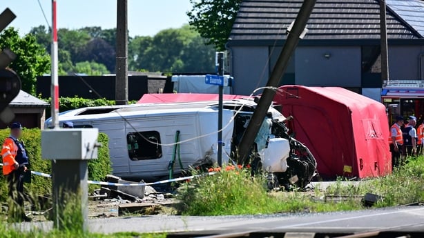 Emergency services pictured at the scene of an collision between a train and a minibus in belgium