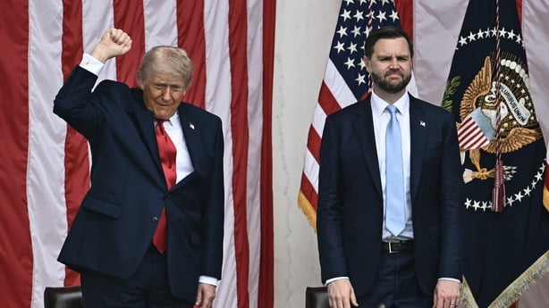 Donald Trump raises his fist alongside JD Vance 