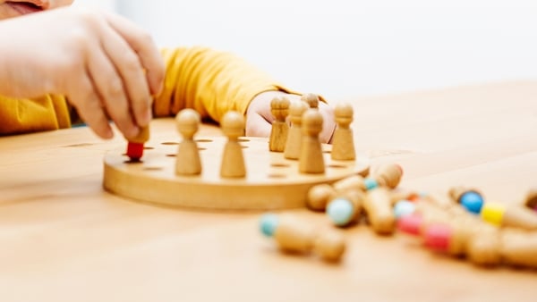 Child playing a board game during education therapy