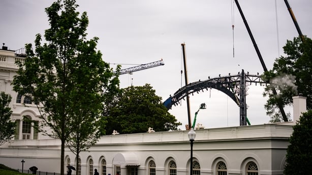 Workers construct a UFC fighting ring outside the White House
