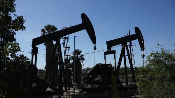 Pumpjacks operate at the Inglewood Oil field in Los Angeles, California on March 17, 2026. Asian markets mostly rose on March 18 and oil prices dipped following another tech-led advance on Wall Street, as the United States hit Iranian missile sites near t