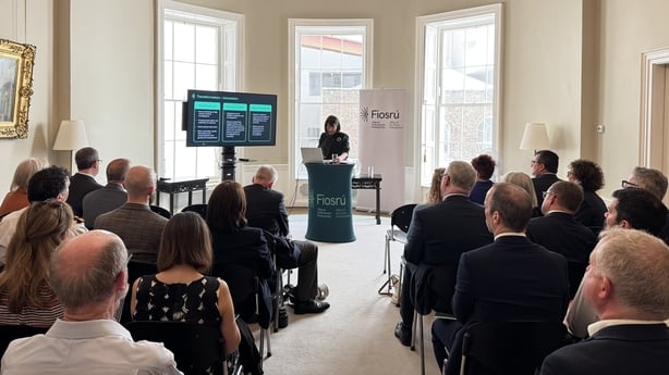 Ombudsman Emily Logan presenting Fiosrú's annual report for 2026 to a room full of people