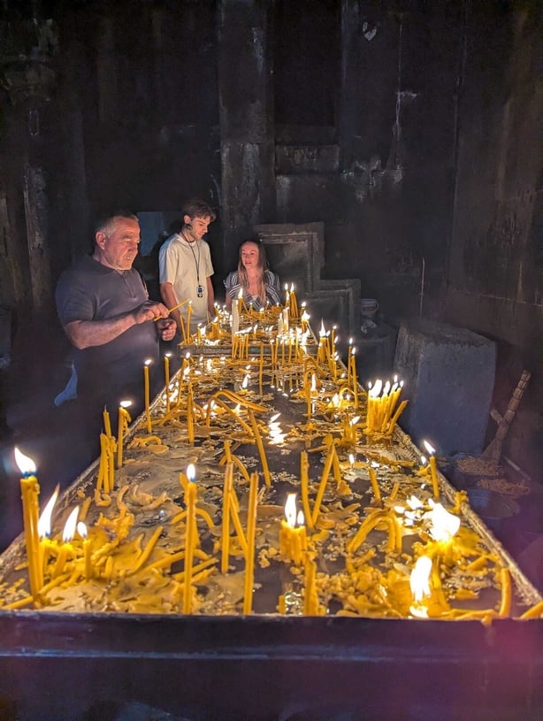 Tourists at a shrine lighting candles