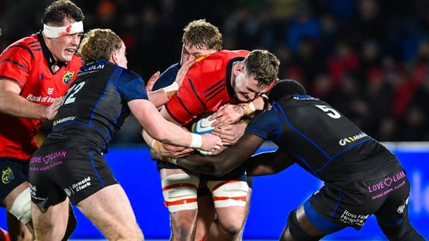 30 January 2026; Evan O'Connell of Munster is tackled by Kerr Yule, left, and Jare Oguntibej of Glasgow Warriors during the United Rugby Championship match between Glasgow Warriors and Munster at Scotstoun Stadium in Glasgow, Scotland. Photo by Rob Casey/Sportsfile
