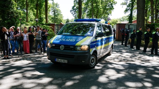 A police car in Germany leaves a courthouse 