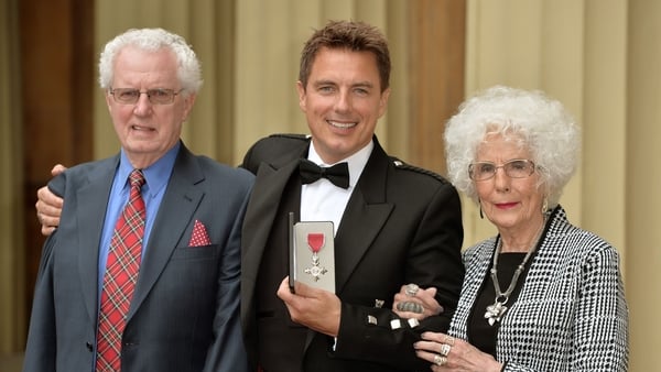 LONDON, ENGLAND - OCTOBER 14: John Barrowman (C) poses with parents John Barrowman (L) and Marion Barrowman (R) after being awarded an MBE at an investiture ceremony at Buckingham Palace on October 14, 2014 in London, England. (Photo by Anthony Devlin - W