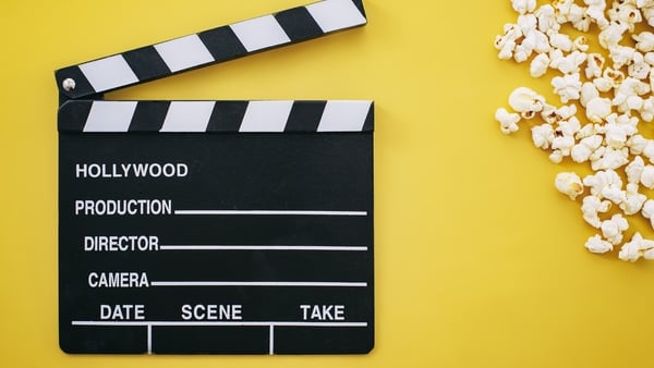 Popcorn and Clapboard On Yellow Background