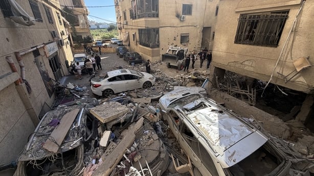 Rescue workers and local residents inspect the damage to a building following an Israeli air strike in the Choueifat area, south of Beirut