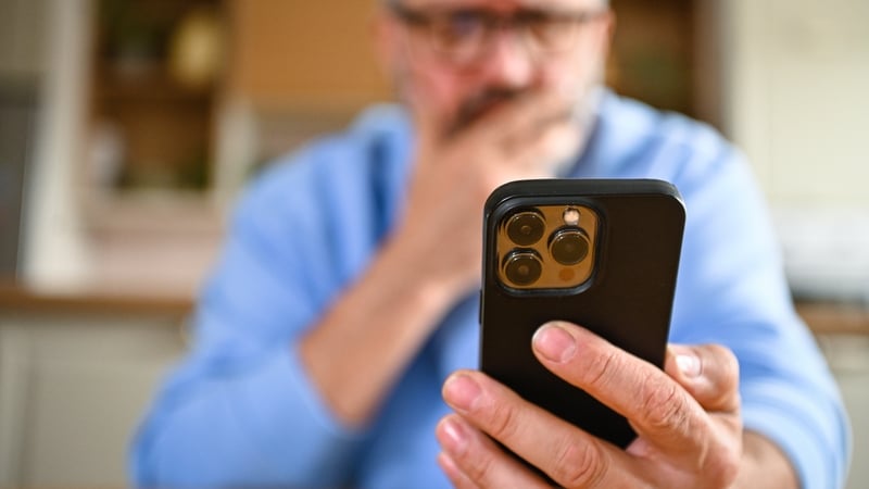 Mature adult man using a mobile phone