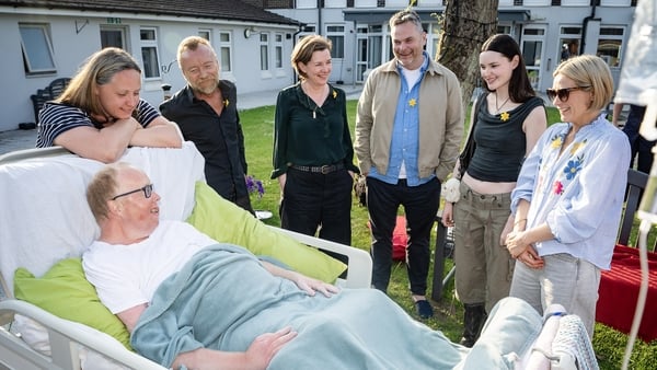 Undated handout photo courtesy of Brian Morrison of inpatient Simon Phillips and his partner Ewelina chatting with Richard Dormer, Joanne Crawford, Declan Lawn, Katherine Devlin and Sian Brooke in the garden at the Marie Curie Hospice in Belfast. Stars fr