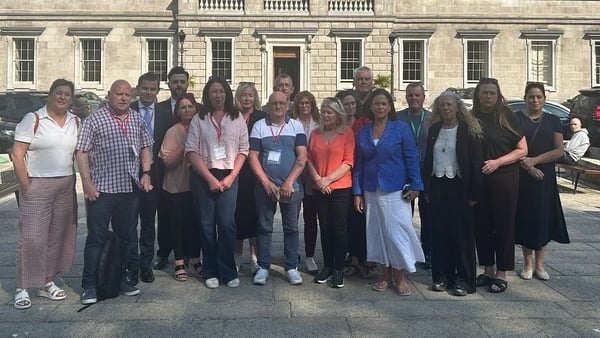 Stardust survivors with Sinn Féin leader Mary Lou McDonald outside Leinster House