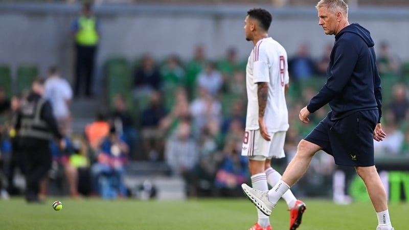 Republic of Ireland head coach Heimir Hallgrimsson clears tennis balls from the pitch during the international friendly match between Republic of Ireland and Qatar at the Aviva Stadium in Dublin.