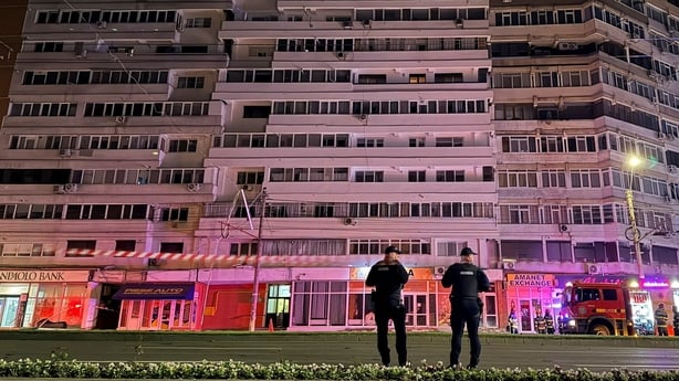 Firefighters and law enforcement work on the site of an explosion at a residential block of flats following a drone hit close to the border with Ukraine