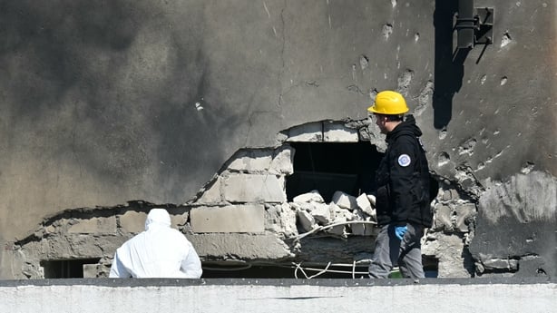 Police and forensic investigators examine the location of impact after a Russian drone struck an apartment building
