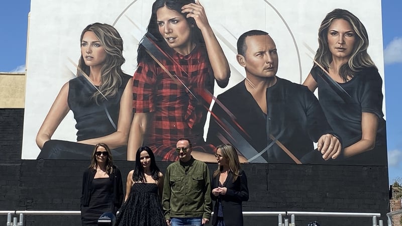 The Corrs pictured in front of a mural of the band in Dundalk
