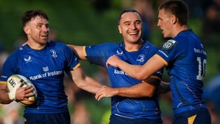 30 May 2026; Hugo Keenan of Leinster, left, celebrates with teammate James Lowe, centre, and Sam Prendergast after scoring their side's second try during the United Rugby Championship quarter-final match between Leinster and Lions at the Aviva Stadium in