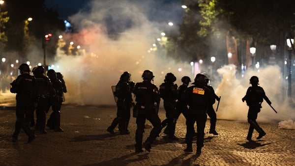 Clashes occur between Paris Saint-Germain (PSG) supporters and police officers using tear gas during celebrations following PSG's win in the UEFA Champions League final against Arsenal FC