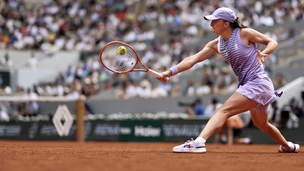 Poland's Iga Swiatek plays a backhand return to Ukraine's Marta Kostyuk