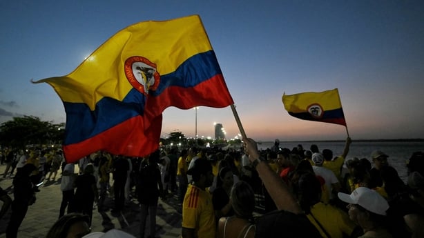 Supporters of Colombia's presidential candidate Abelardo de la Espriella, of the Salvadores de la Patria movement, wave national flags as they celebrate during the first exit poll results of the presidential election in Barranquilla, Colombia, on May 31, 2026. (Photo by Rodrigo BUENDIA / AFP)