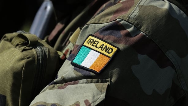 An Ireland flag badge on the arm of a soldier's uniform