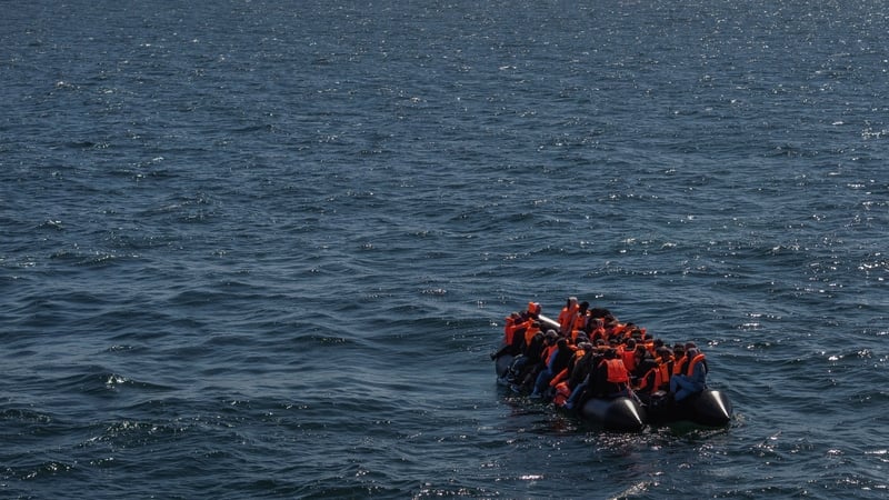 a small boat carrying people wearing red life jackets