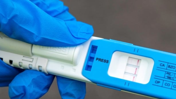 a garda roadside drugs test is seen being held by a hand in a blue surgical glove