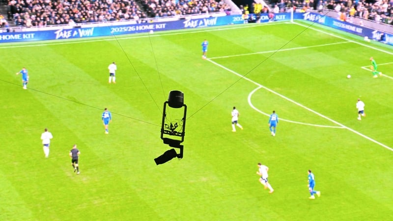 A TV remote spider cam is pictured in front a screen showing live action of the English Premier League football match between Tottenham Hotspur and Chelsea at the Tottenham Hotspur Stadium in London, on November 1, 2025. (Photo by JUSTIN TALLIS / AFP) / R