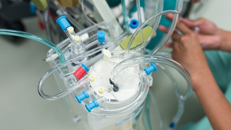Close up of machines and plastic pipes as a perfusionist prepares heart lung bypass