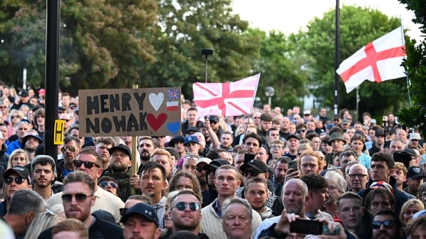 Protesters gather outside a police station in the UK 