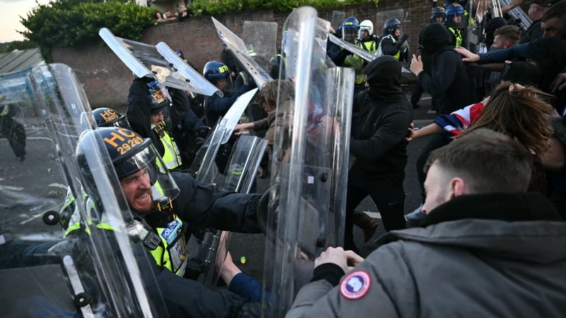 Protestors confront riot police in the UK