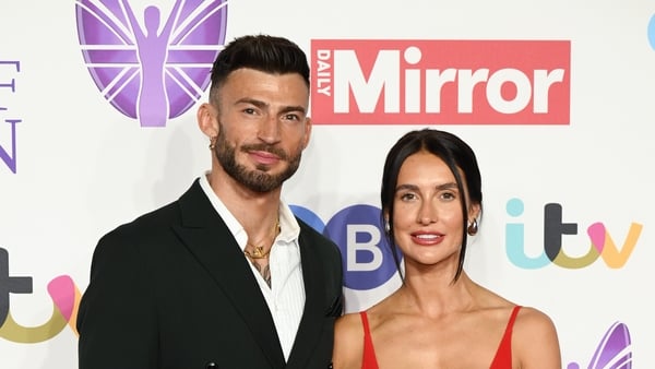 X factor star and his wife on red carpet